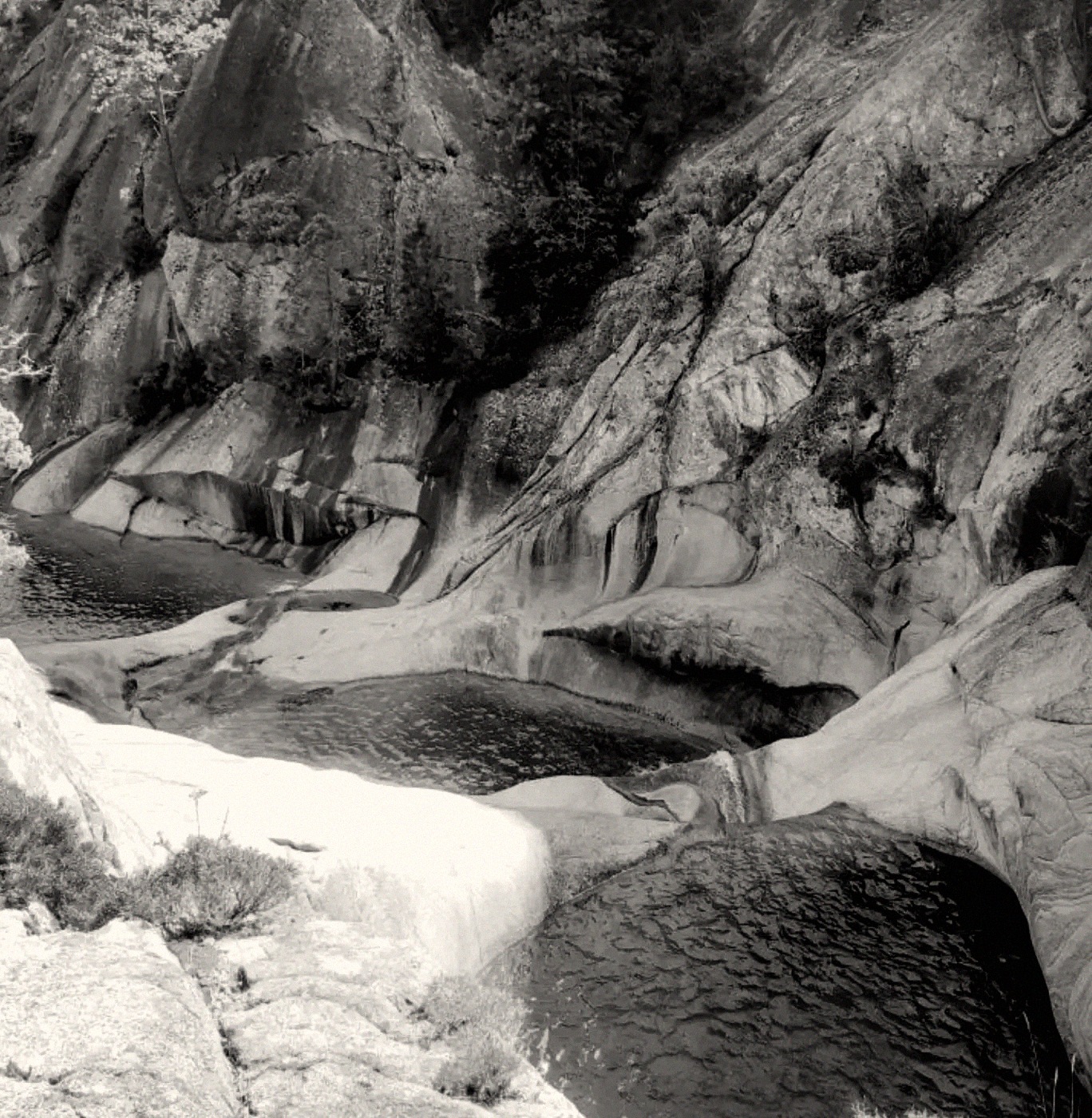 Black and white photograph of granite rock pools and waterfalls in the Corsican mountains