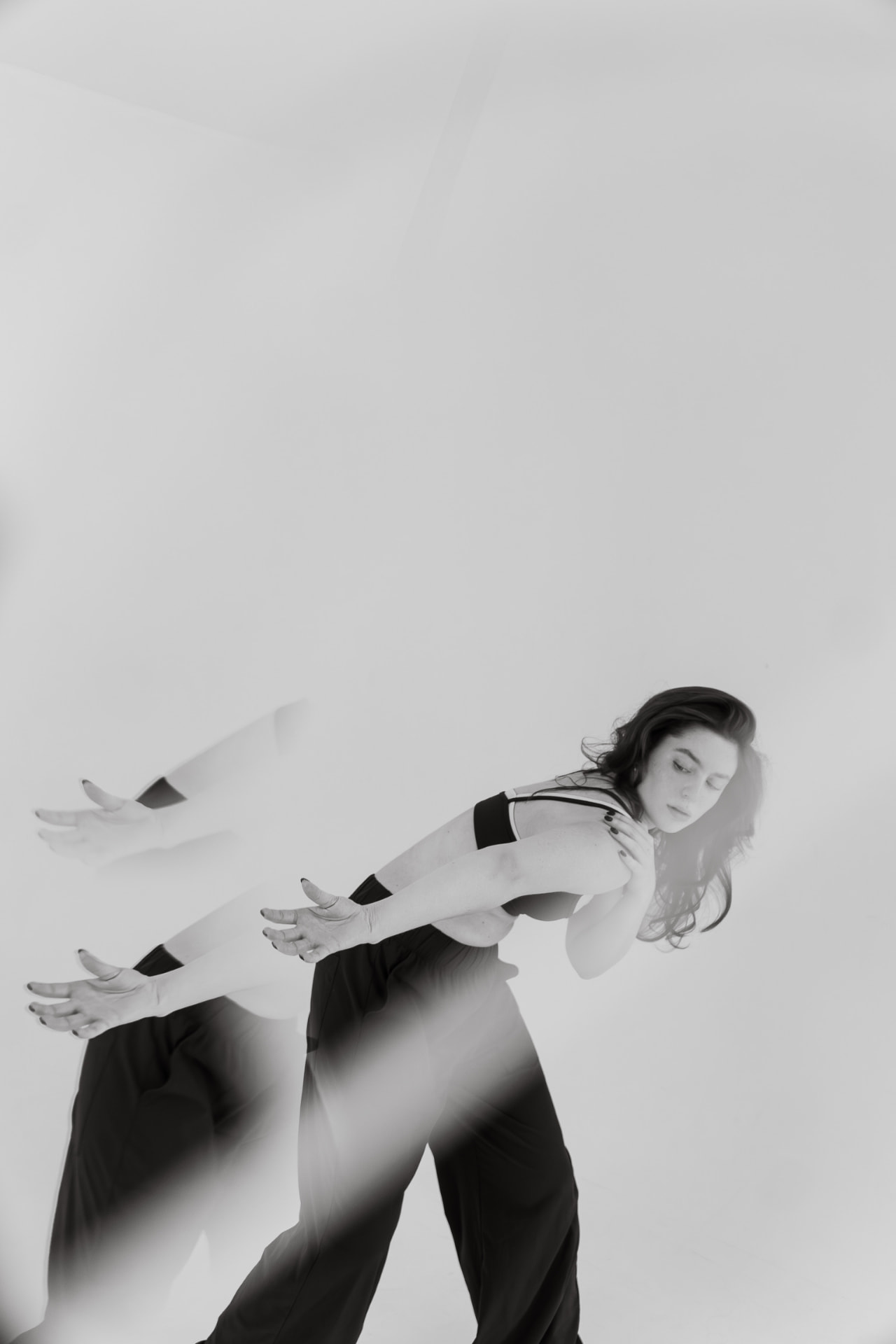 Black and white multi-exposure photograph of a dancer in motion